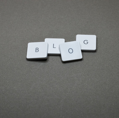 Four Scrabble tiles spelling the word blog.