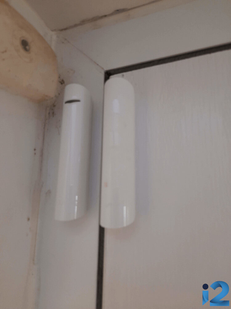 Ajax DoorProtect Plus on the front door of a UK home.