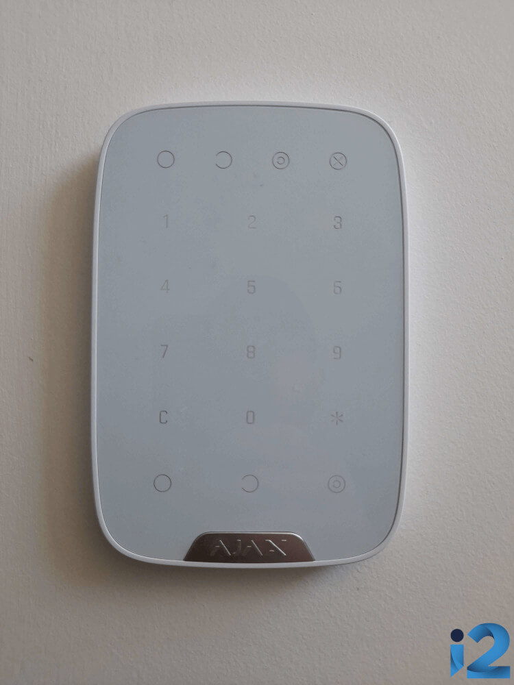 Ajax KeyPad on a wall in a house.