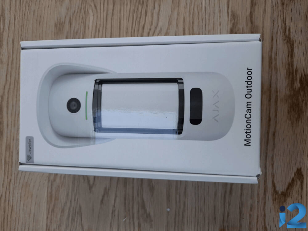 A boxed Ajax MotionCam Outdoor on a table.