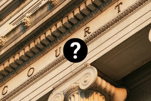 Courthouse with question mark symbol representing uncertainty about Martyn's Law compliance requirements.