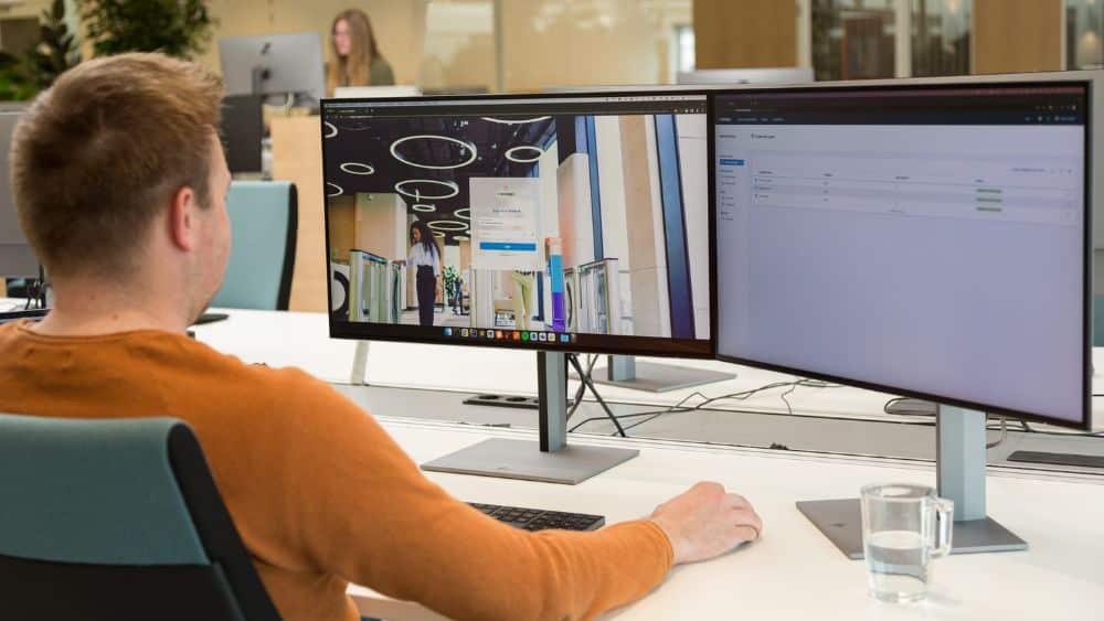 Nedap Access AtWork access control software displayed on office monitors for workplace security management.
